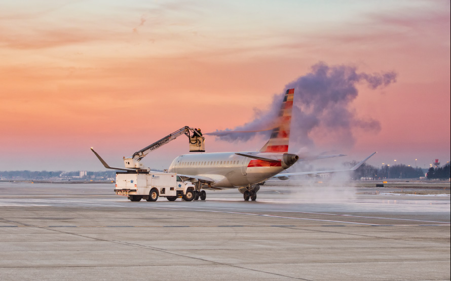 Aircraft undergoing professional de-icing service at sunrise in Columbus, Ohio to ensure safe winter departures.