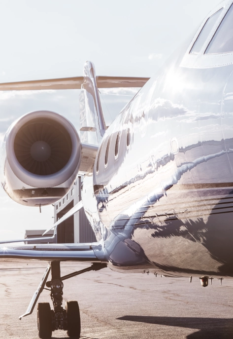 Close-up of private jet engine and fuselage reflecting sunlight at Columbus Ohio airport FBO