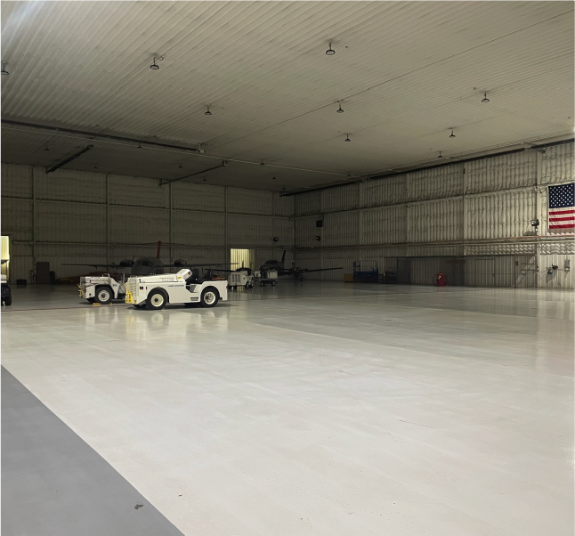 private-aircraft-hangar-interior Large private aircraft hangar with aviation ground support equipment.