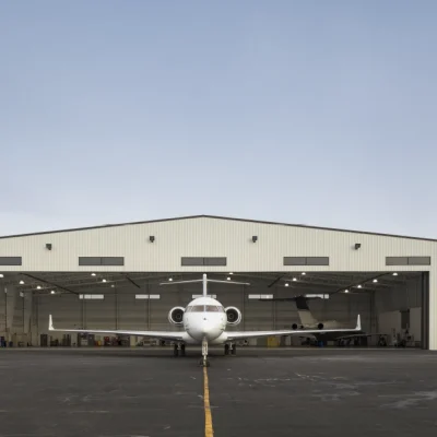 Private jet positioned in front of the Lane Aviation aircraft hangar in Columbus, Ohio, illustrating private jet charter services and aircraft management.