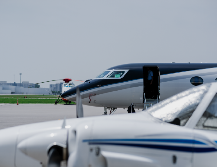 Private aircraft parked on the airport tarmac for aviation services and ground operations.